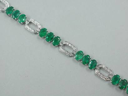null 18k white gold line bracelet set with 18 oval emeralds weighing 14cts in total,...