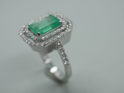 null 18k white gold ring set with an emerald cut emerald of 2cts in an openwork setting...
