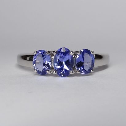 null Trilogy ring in 18k white gold set with three oval tanzanites for a total weight...