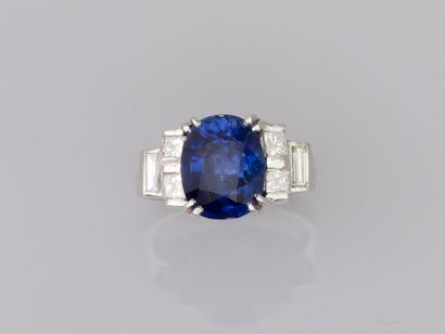 null 18k white gold ring set with a 4.50ct sapphire and cushion and baguette cut...
