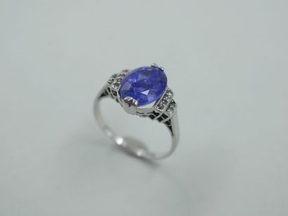 null Platinum ring set with an oval tanzanite of about 4.50cts and small diamonds....
