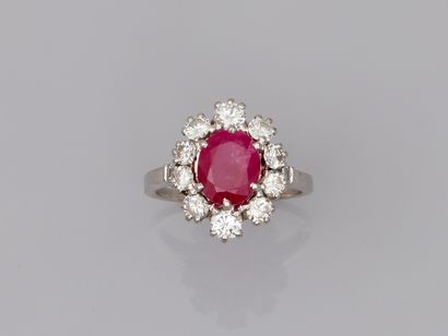 Platinum flower ring with an oval ruby of...