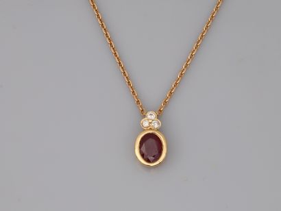 null 18k yellow gold pendant with an oval ruby of 2.6cts approximately, topped by...