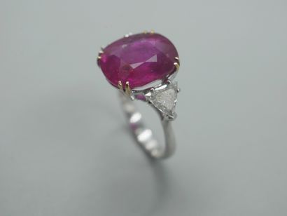 null 18k white gold ring set with a large oval ruby in a claw setting weighing approximately...