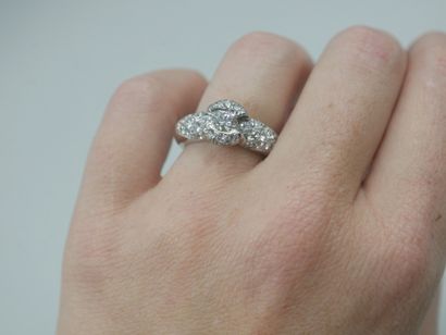 null 18k white gold ring centered with a brilliant-cut diamond in a pavé diamond...