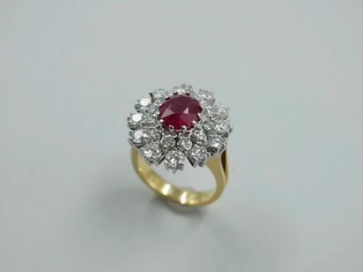 null Important 18k white and yellow gold flower ring centered on an oval ruby of...