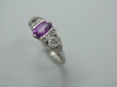 null 18k white gold ring centered on an oval pink sapphire surrounded by two lines...