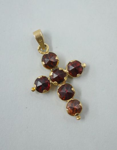 null Cross in 18k yellow gold decorated with faceted garnets. 

Length: 3cm. PB :...