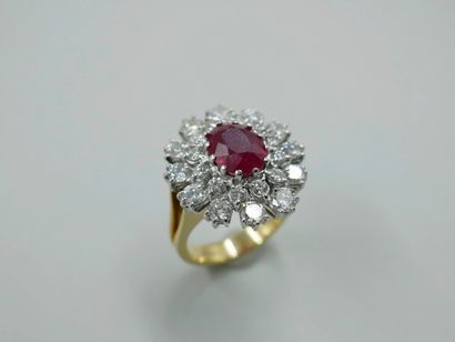 null Important 18k white and yellow gold flower ring centered on an oval ruby of...