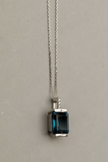 null Pendant Design in 18k white gold topped with an emerald-cut London Blue topaz...