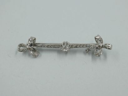 null Platinum bow brooch set with an old cut diamond and enhanced with rose cut diamonds....