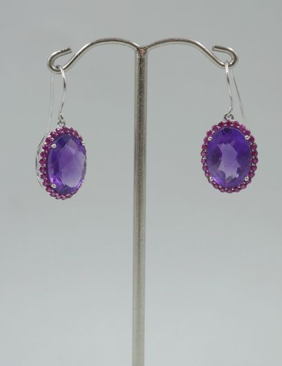 null Pair of 18k white gold earrings set with an oval faceted amethyst surrounded...