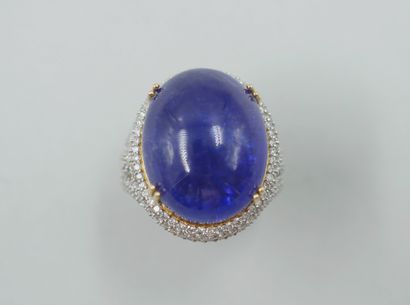 null 18k yellow gold ring with a cabochon tanzanite of 30cts in a claw setting in...