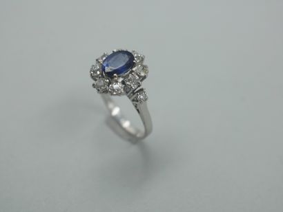 null 18k white gold flower ring centered with a sapphire surrounded by brilliant-cut...