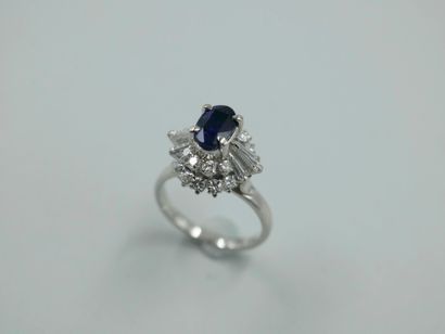 null 
Platinum skirt ring set with an oval synthetic sapphire and marquise-cut diamonds...