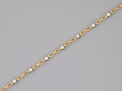 null 18k yellow gold and platinum openwork bracelet with ten diamonds in closed setting.

Length...