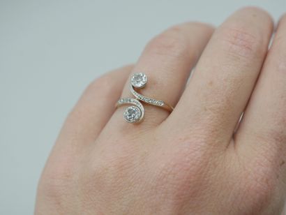 null A 14k yellow gold and platinum Vous Moi ring with a scroll design adorned with...