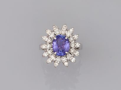 null Daisy ring in 18k white gold surmounted by an oval tanzanite of about 2.50cts...