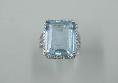 null 18k white gold ring set with a large rectangular aquamarine of about 13cts encircled...