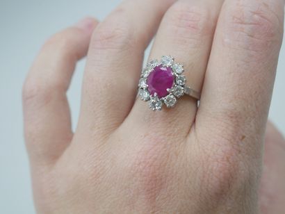 null Platinum flower ring with an oval ruby of 2.50cts in a diamond setting. 

PB...