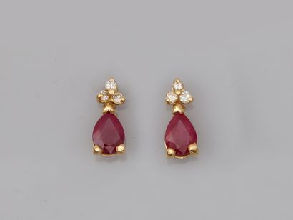 null Pair of 18k yellow gold earrings set with drop rubies of about 1.20cts each,...