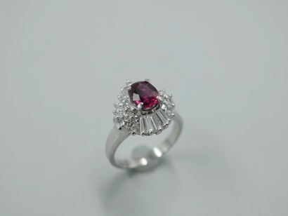 null 
Platinum skirt ring set with an oval ruby and marquise-cut diamonds in a double...