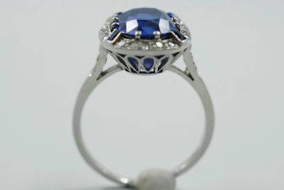 null 
Platinum ring surmounted by a 7.50cts unheated cushion-cut Vivid Blue sapphire...