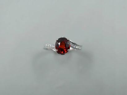 null 18k white gold ring set with a round spessartite garnet of about 2cts, with...