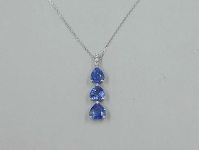 null Pendant trilogy in 18k white gold set with three pear-cut sapphires. Pave diamonds...