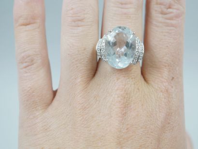 null 18k white gold ring set with a large aquamarine of about 12cts in a double shoulder...