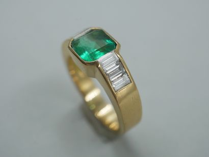 null 18k yellow gold ring set with a Colombian emerald and six baguette diamonds....