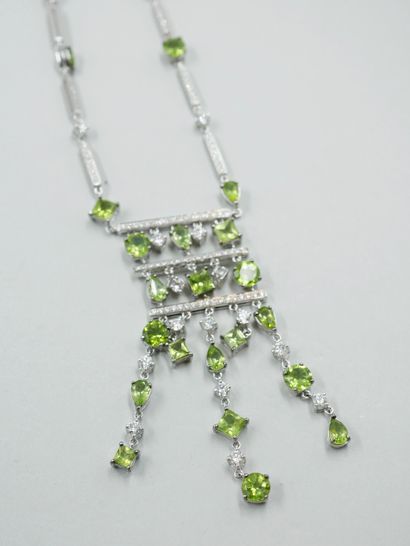 null 18k white gold drapery necklace set with lines of diamonds in bars holding peridots...