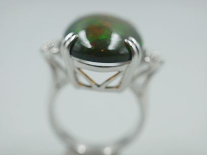 null Ring in 18k white gold surmounted by a black opal cabochon of about 10cts flanked...