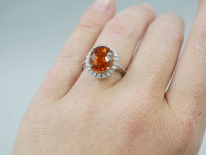 null 18k white gold ring set with a spessartite garnet of about 3cts in a diamond...