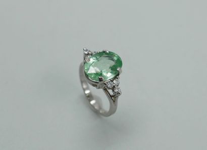 null Rhodium-plated 18k white gold ring surmounted by an oval green paraiba tourmaline...