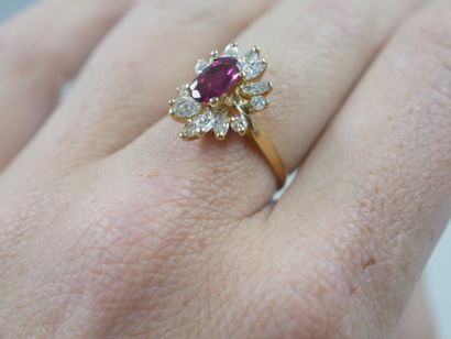 null 18k yellow gold flower ring centered on an oval ruby in a surround of marquise...