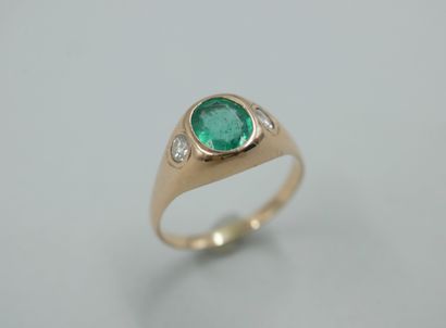null Ring in 18k yellow gold set with an oval emerald and two diamonds in closed...
