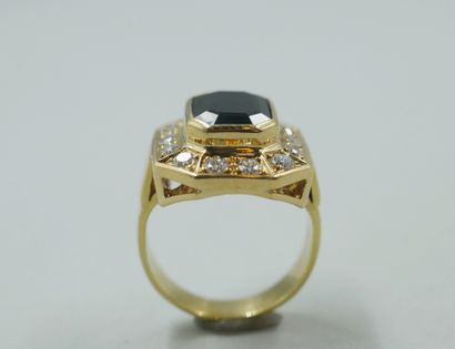 null Octagonal ring in 18k yellow gold set with an oval sapphire in a closed setting...