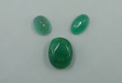 null Two oval emeralds on paper. 

With an emerald root bead.