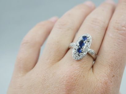 null Marquise ring in 18k white gold set with three oval sapphires in a diamond setting....