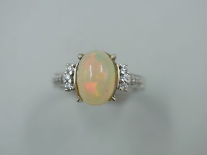 18k white gold ring set with an opal and...