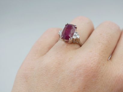 null 18k white gold ring set with a 5.09cts oval natural ruby and baguette-cut diamonds....