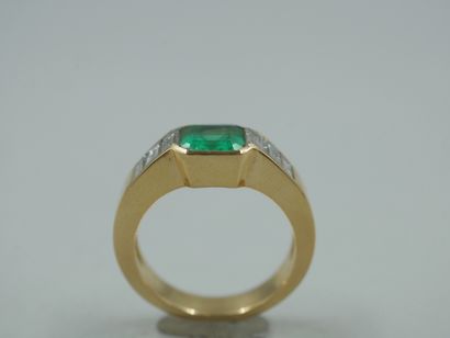 null 18k yellow gold ring set with a Colombian emerald and six baguette diamonds....