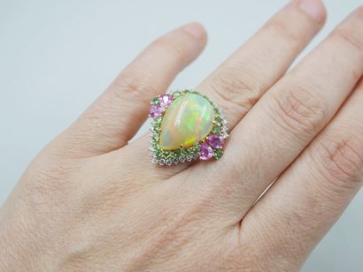 null 18k white gold ring surmounted by a cabochon-cut pear-shaped opal of 8cts approximately...