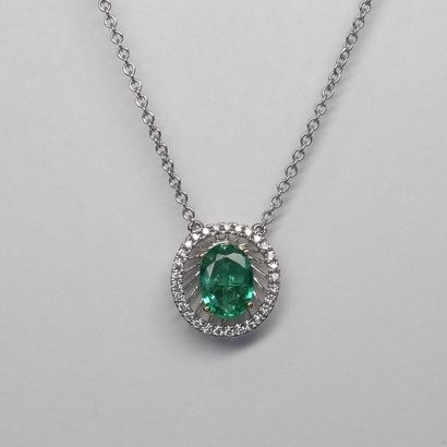 null Necklace in 18k white and yellow gold with an oval emerald of 0.60 ct set in...