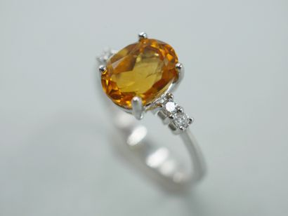 null 18k white gold ring with an oval faceted citrine of about 1ct and diamonds....