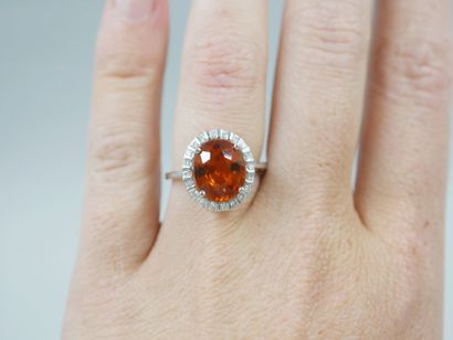 null 18k white gold ring set with a spessartite garnet of about 3cts in a diamond...