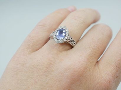null 14k white gold pompadour ring set with an oval sapphire in a diamond setting...