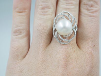 null 18k white gold ring centered on a South Sea pearl, 12mm diameter, in a swirling...
