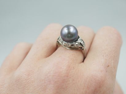 null Ring in 18k white gold set with a grey Tahitian pearl on a diamond setting....
